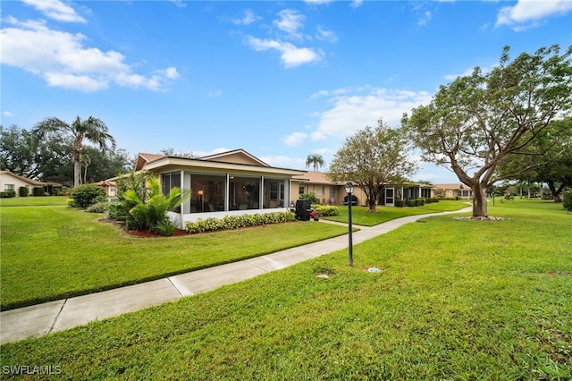 view of front of property with a sunroom and a front yard