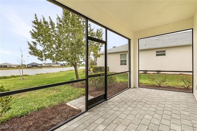 unfurnished sunroom with a water view