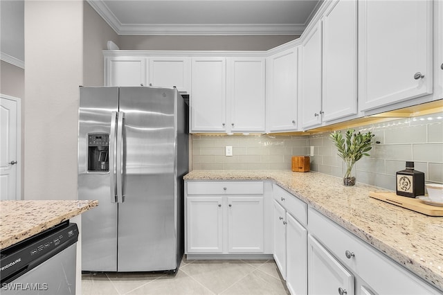 kitchen with white cabinets, light stone countertops, appliances with stainless steel finishes, and tasteful backsplash