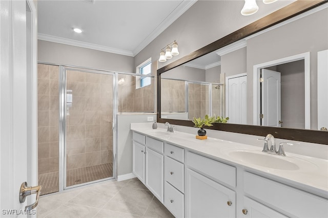 bathroom with vanity, tile patterned floors, ornamental molding, and a shower with door