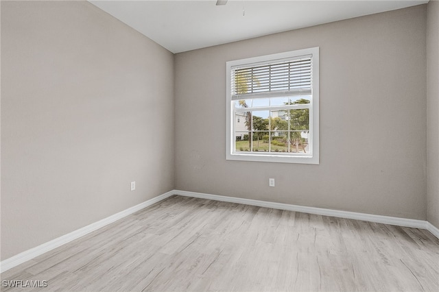 spare room featuring light hardwood / wood-style floors and ceiling fan