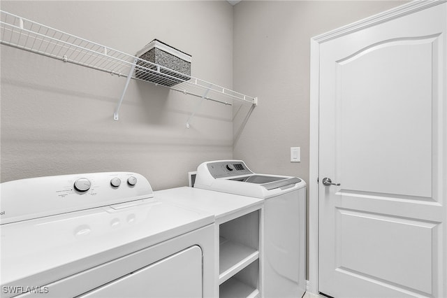 clothes washing area with separate washer and dryer