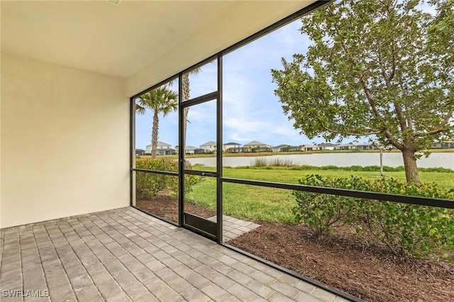 unfurnished sunroom with a water view