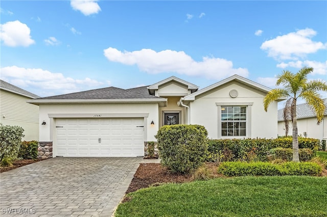 ranch-style house with a garage and a front yard