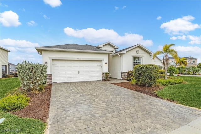 view of front of house with a front yard and a garage