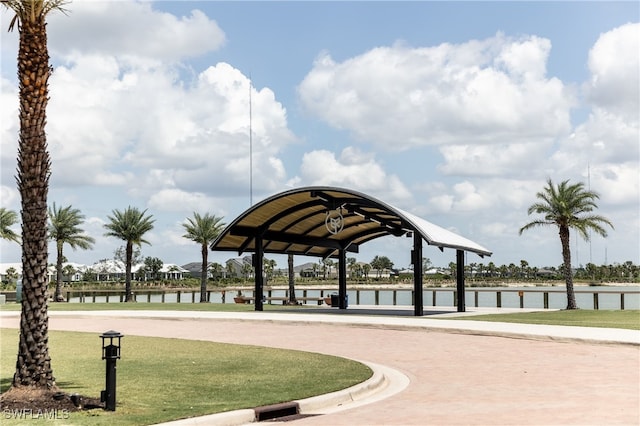 view of property's community with a water view and a yard