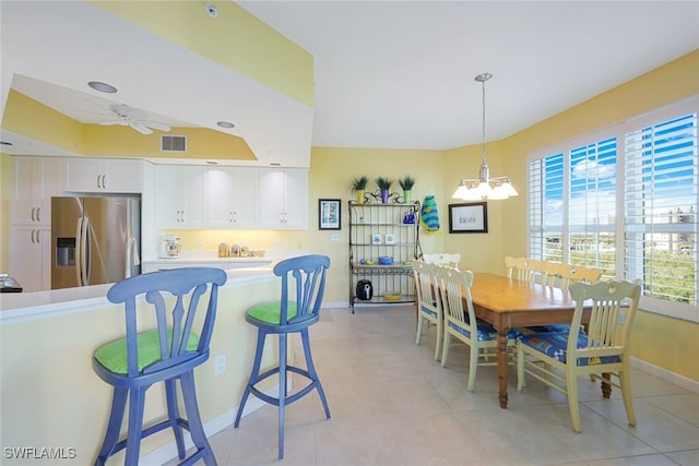 dining area featuring ceiling fan with notable chandelier and light tile patterned floors