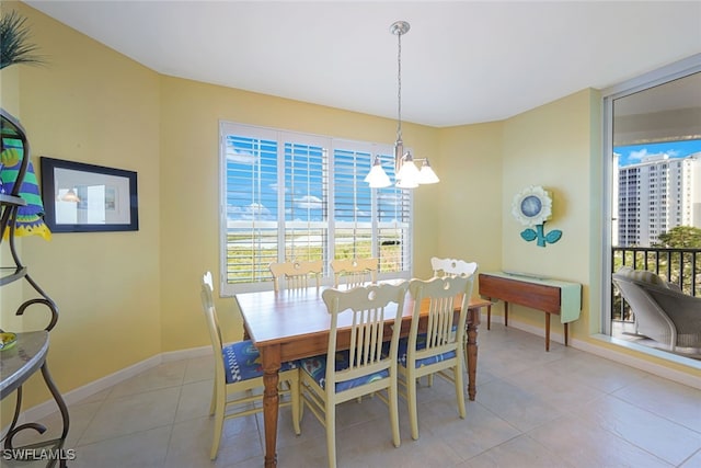 tiled dining space featuring an inviting chandelier