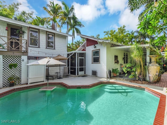 view of pool with a patio and a lanai