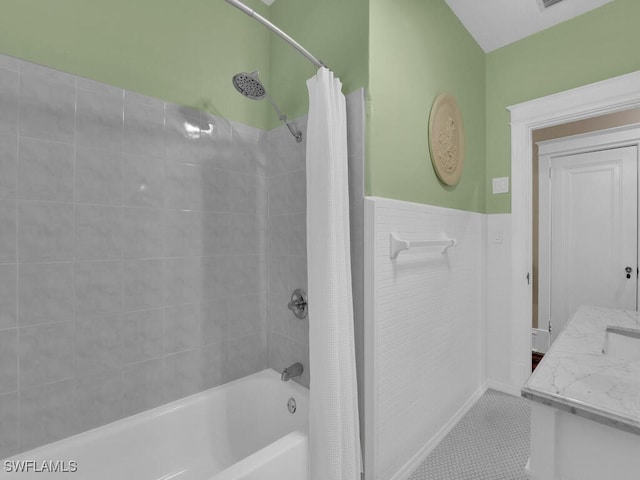 bathroom with shower / tub combo, vanity, and tile patterned flooring