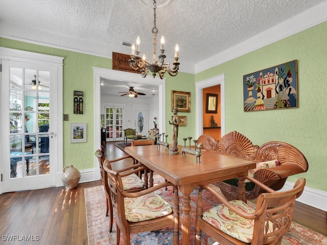 dining room featuring ceiling fan with notable chandelier, hardwood / wood-style floors, and a textured ceiling