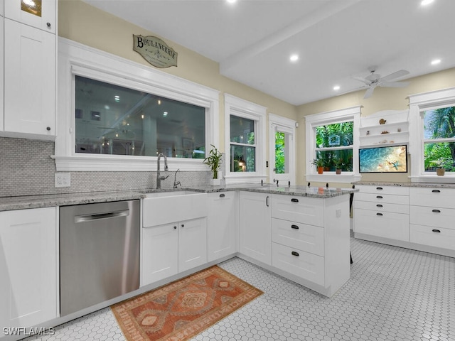 kitchen featuring a healthy amount of sunlight, dishwasher, decorative backsplash, and white cabinets