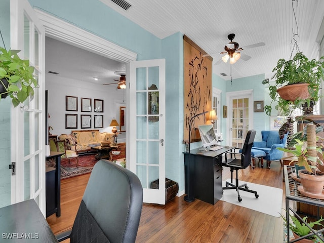 home office featuring ceiling fan, dark hardwood / wood-style flooring, and french doors