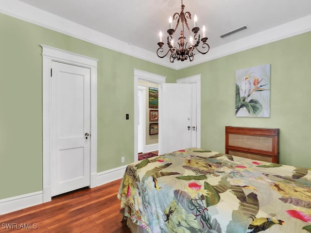 bedroom with ornamental molding and dark hardwood / wood-style floors