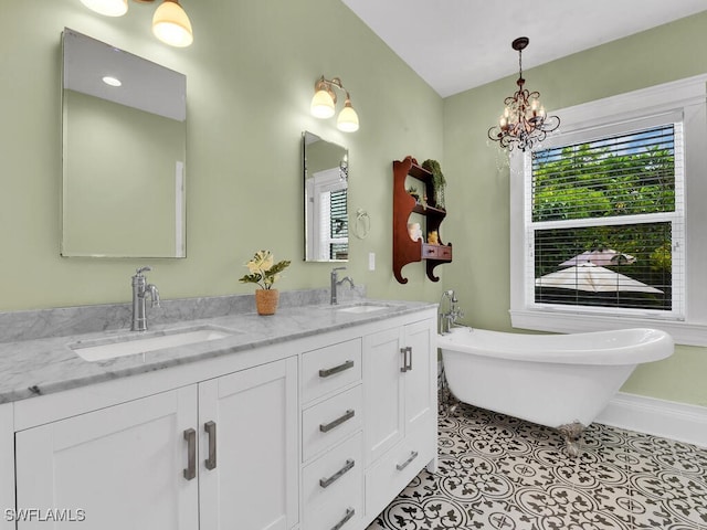 bathroom featuring tile patterned flooring, vanity, a bath, and a chandelier