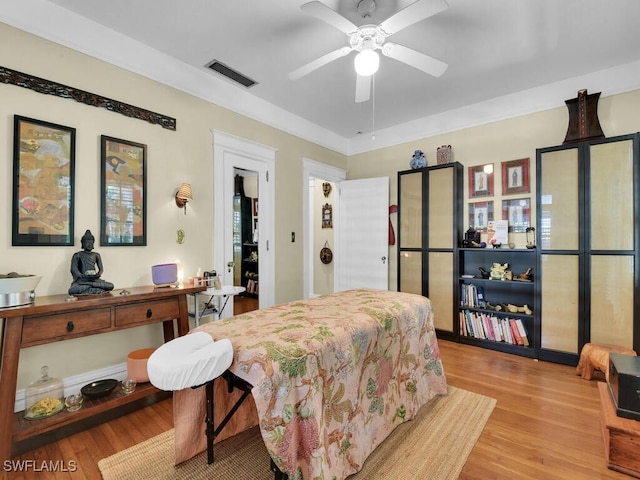 bedroom with light hardwood / wood-style flooring and ceiling fan