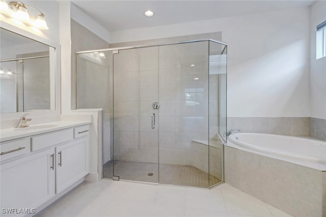 bathroom featuring independent shower and bath, vanity, and tile patterned floors