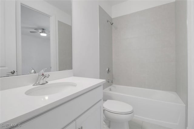 full bathroom featuring vanity, ceiling fan, tiled shower / bath combo, and toilet