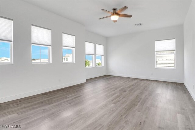 spare room with ceiling fan and light hardwood / wood-style flooring