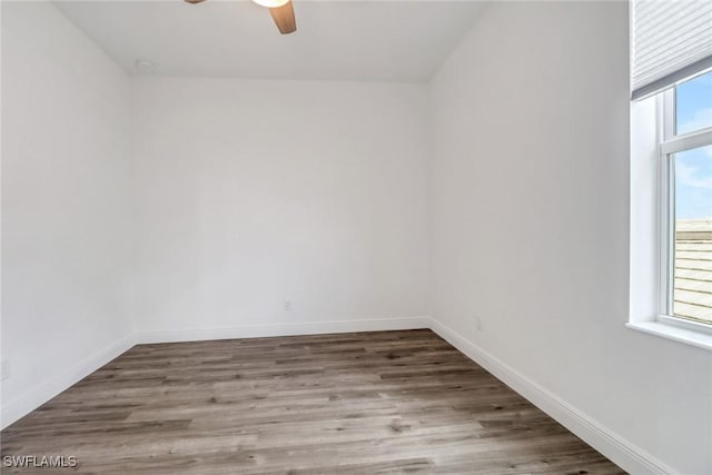 spare room featuring hardwood / wood-style flooring, a wealth of natural light, and ceiling fan