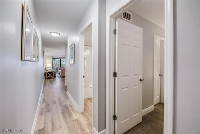 hall with light wood-type flooring