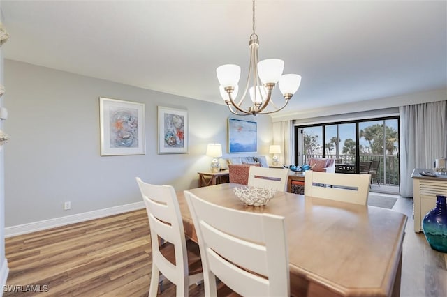 dining room featuring an inviting chandelier and light wood-type flooring