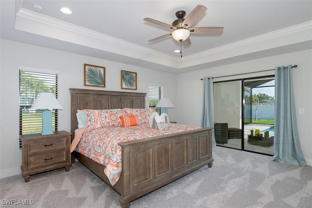 carpeted bedroom featuring ceiling fan, access to exterior, crown molding, and a raised ceiling