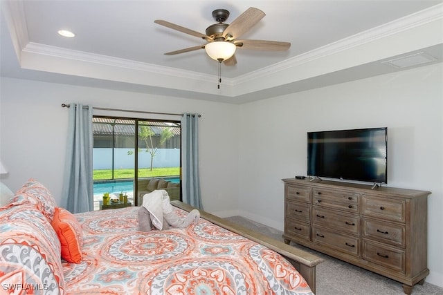 carpeted bedroom with ceiling fan, ornamental molding, a tray ceiling, and access to outside