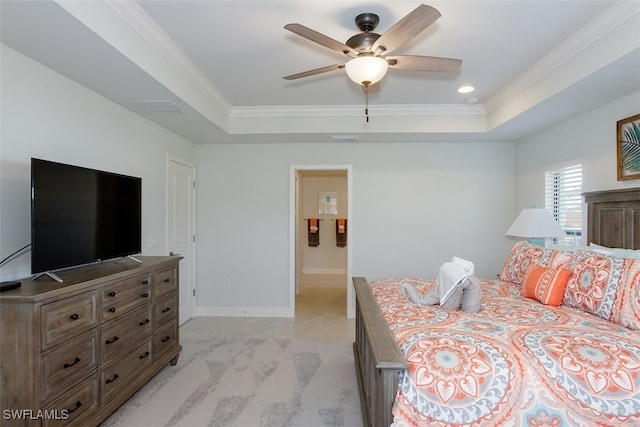 carpeted bedroom featuring ceiling fan, ornamental molding, and a raised ceiling