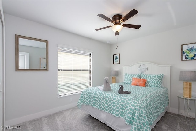 carpeted bedroom with ceiling fan and multiple windows