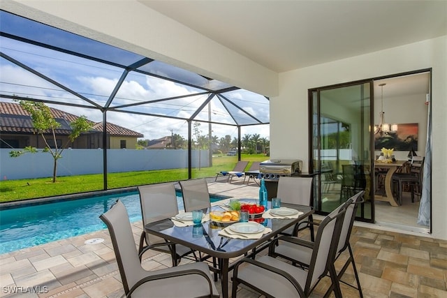 view of patio / terrace featuring glass enclosure and a fenced in pool