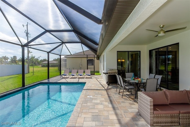 view of swimming pool featuring a lanai, an outdoor living space, a patio, and ceiling fan