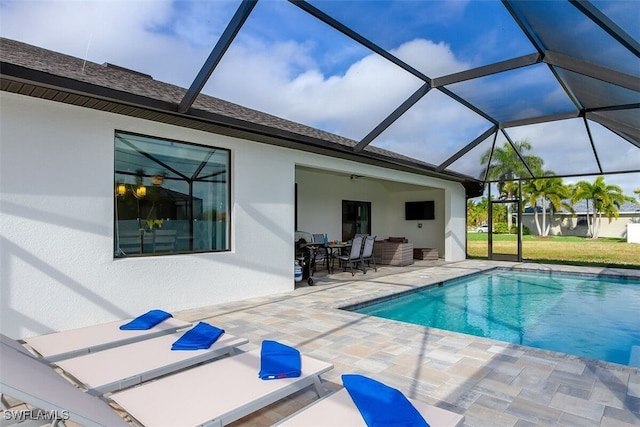 view of swimming pool with a lanai and a patio