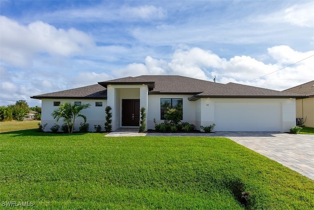 view of front of house with a garage and a front lawn