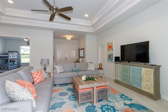 living room featuring ornamental molding and a raised ceiling