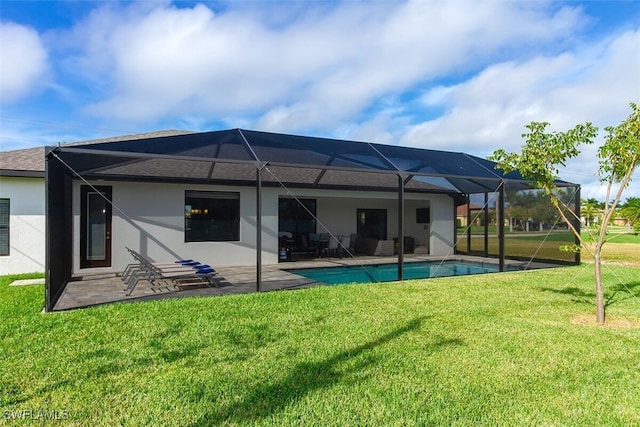 back of property featuring a lanai, a patio area, and a yard