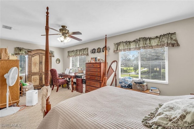 carpeted bedroom with ceiling fan and multiple windows