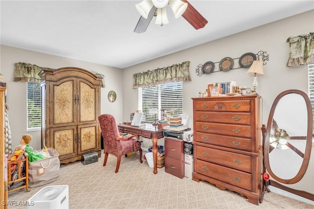 carpeted home office with ceiling fan and plenty of natural light