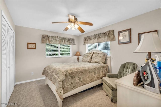 bedroom featuring ceiling fan, a closet, and light carpet