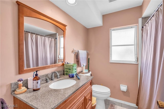 bathroom featuring tile patterned floors, vanity, and toilet