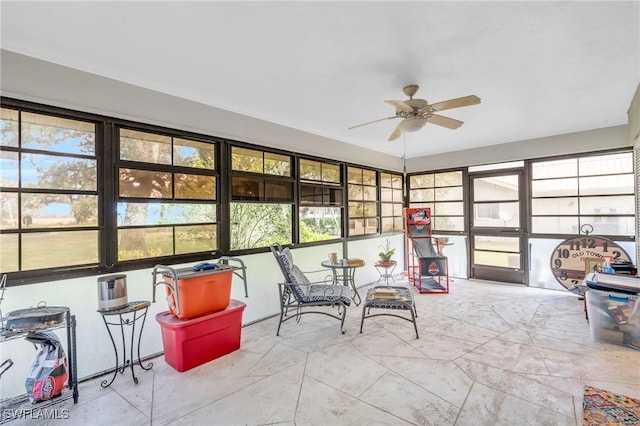 sunroom / solarium featuring ceiling fan