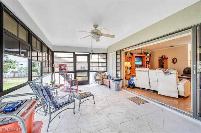 sunroom / solarium featuring ceiling fan