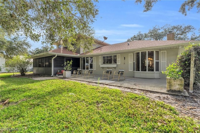 back of property featuring a sunroom, a lawn, and a patio