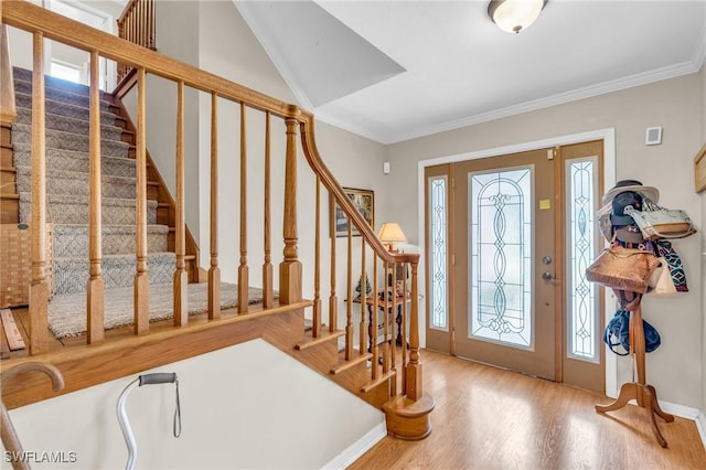 entrance foyer featuring hardwood / wood-style floors and crown molding