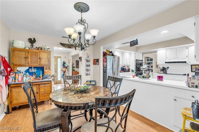 dining room featuring a chandelier and light hardwood / wood-style floors