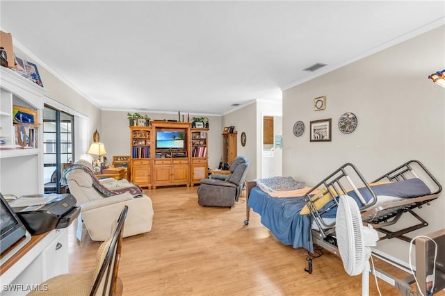 living room featuring crown molding and light hardwood / wood-style floors