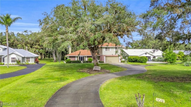 view of front of house featuring a front lawn and a garage