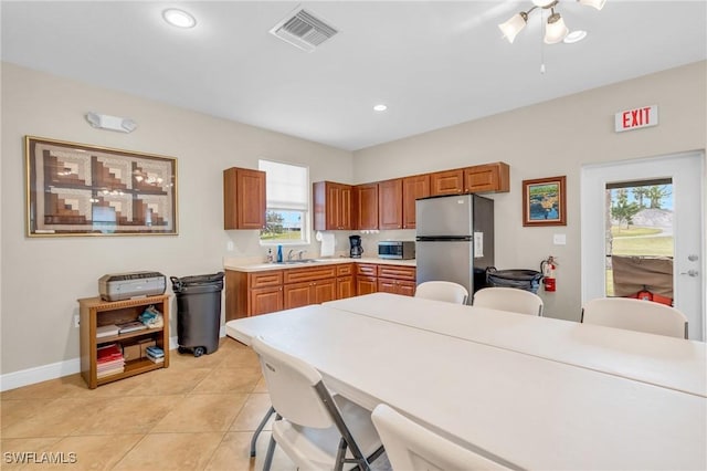 kitchen featuring ceiling fan, light tile patterned floors, appliances with stainless steel finishes, and sink