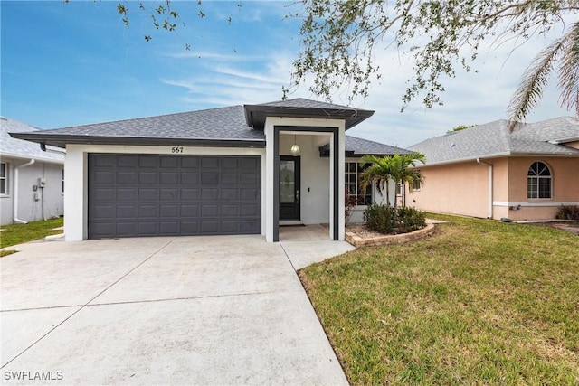 view of front of home featuring a front yard and a garage