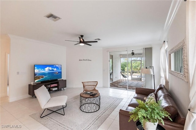 living room featuring ceiling fan, light tile patterned floors, and ornamental molding